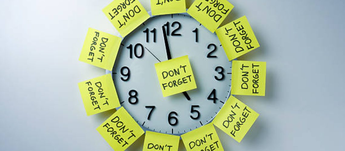 "don't forget" adhesive note papers on the office clock